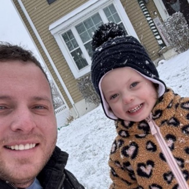 Mark and his daughter smiling in the snow